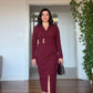 WRAP-STYLE V-NECK LONG-SLEEVE MIDI DRESS WITH DRAPING AND GOLD-TONE ACCENT - BURGUNDY