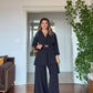WRAP SUIT WITH GOLD BUCKLE DETAIL – BLACK